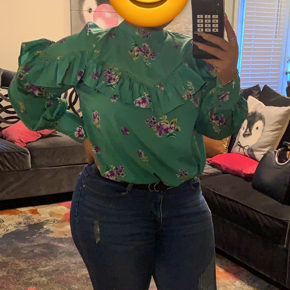 Very pretty blouse with flower pattern and ruffles throughout.